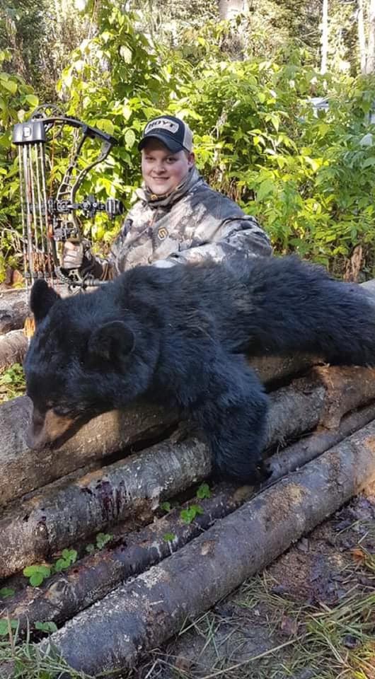 Clayton with his fall bear , shot with his Hoyt bow at 17 yards away